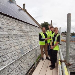 Liskeard Town Councillors and contractors on the roof of the Public Hall with the new solar panels in 2015